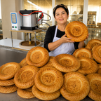 Commercial bakery flatbread production scene with KONBRIT dough press machine